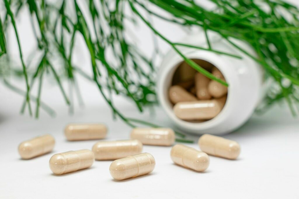 Capsules beside a supplement bottle
